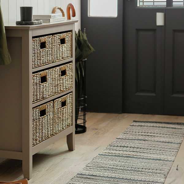 Wooden 6 drawer unit in grey with wicker baskets.